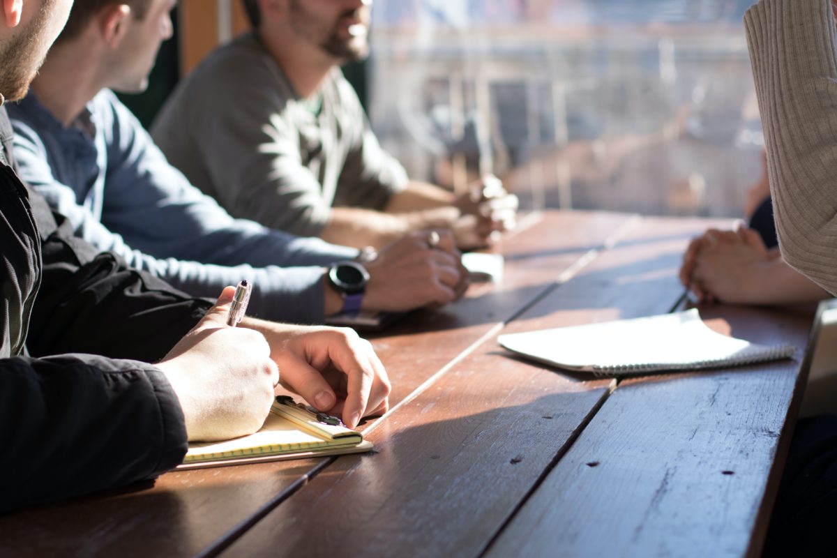 Business meeting with pads on desk